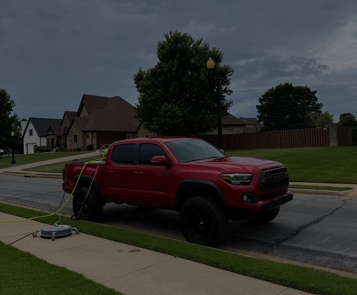 Southern Exterior work truck cleaning a driveway in a Northwest Arkansas neighborhood